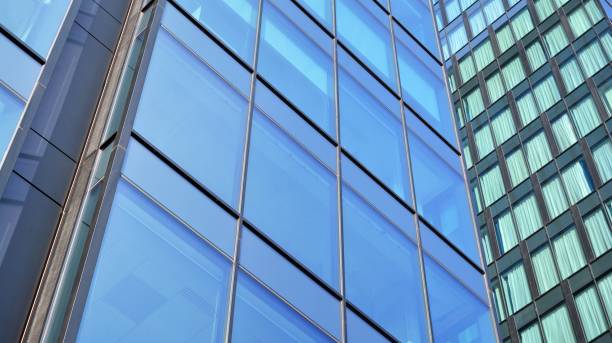 istock Modern office building with glass facade on a clear sky background. 1311895338