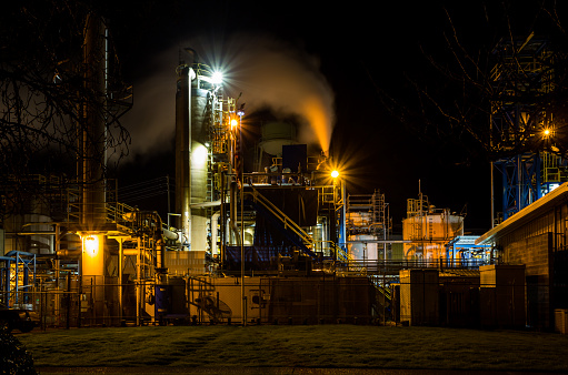 Albany, Oregon, USA - February 17th, 2021: Illuminated at night the huge impressive plant of Georgia-Pacific Company, one of the world’s leading makers of tissue, pulp, packaging, building products