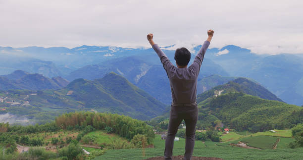 istock male traveler stand on peak 1311899820