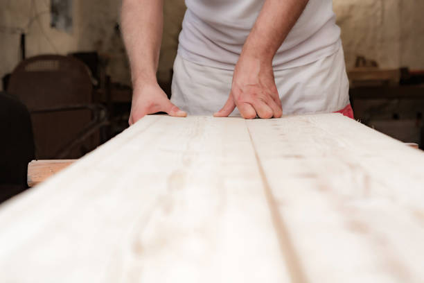 istock Male carpenter working with wood material in a garage. 1311901541