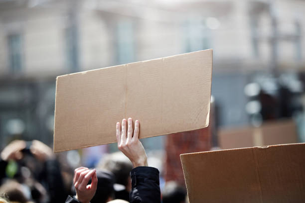istock Protesters holding placards and signs on the streets. 1311901615