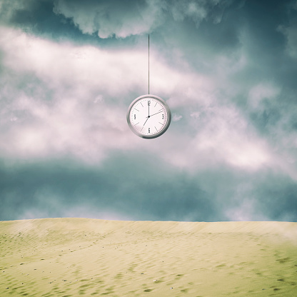 Clock from the cloudy sky, over the sand dunes. Square orientation. Time, sand. Time concept. Business
