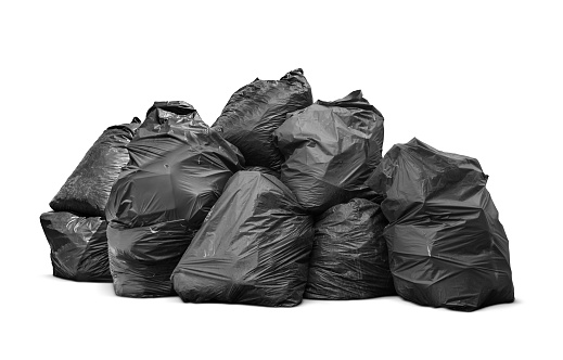 Black garbage bags stack or Waste plastic bags isolated on white background with clipping path, environment concept