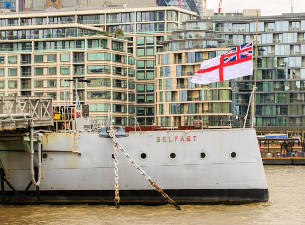 HMS Belfast with Half-Mast on River Thames HMS Belfast flying the flag at half mast in honour of the death of Prince Philip, The Duke of Edinburgh. River Thames, London 10th April 2021 prince phillip stock pictures, royalty-free photos & images