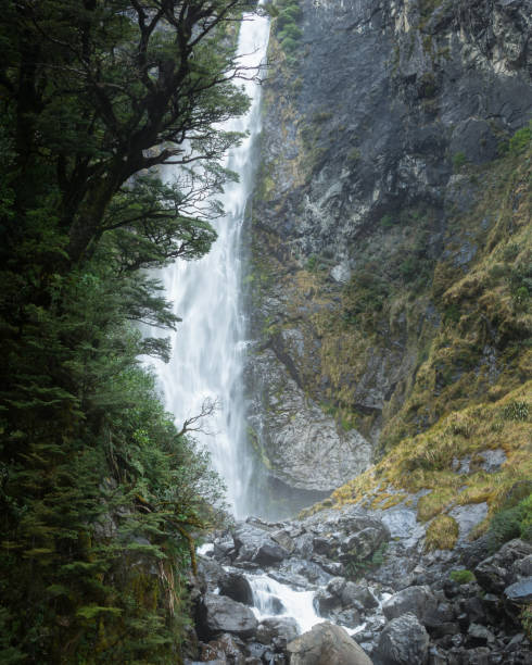 istock Thundering Devil's Punchbowl waterfall in Arthur's Pass, South Island, New Zealand 1311907499