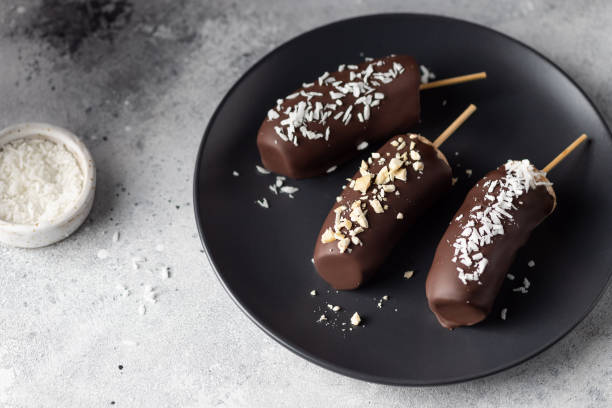 istock Frozen bananas with nuts and coconut on dark plate 1311907699