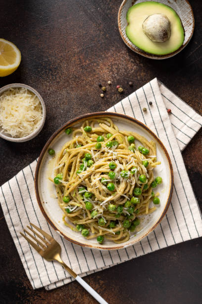 istock Whole wheat pasta spaghetti with green peas and avocado 1311908562