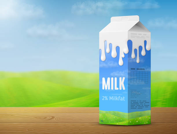 istock Milk package on wooden table on background of blurred landscape 1311908628