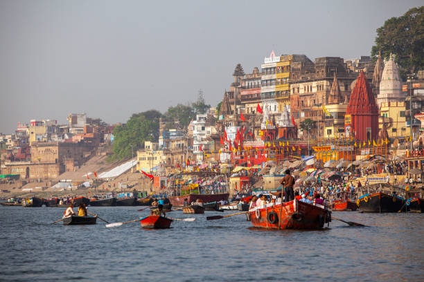 Boats moored in front of ghats on the River Ganges, Varanasi, Uttar Pradesh, India Varanasi, India - April 6, 2010: Boats moored in front of ghats on the River Ganges, Varanasi, Uttar Pradesh, India. Varanasi has always attracted a large number of pilgrims and worshippers from time immemorial.  Varanasi – The Spiritual Epicenter stock pictures, royalty-free photos & images