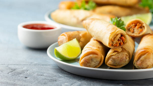 istock Fried spring rolls with sweet chili sauce and lime on plate 1311913413