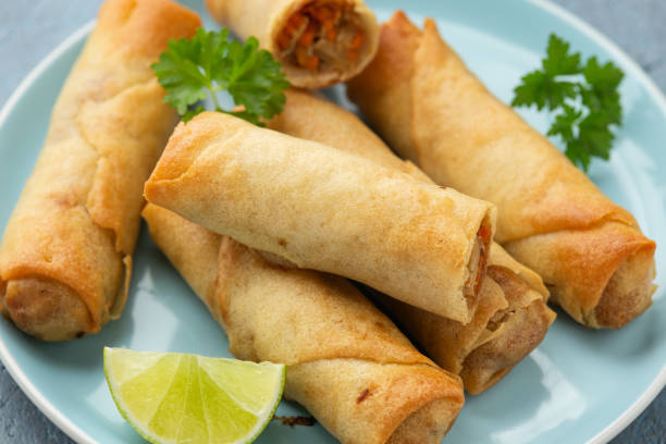 istock Fried spring rolls with sweet chili sauce and lime on plate 1311913459