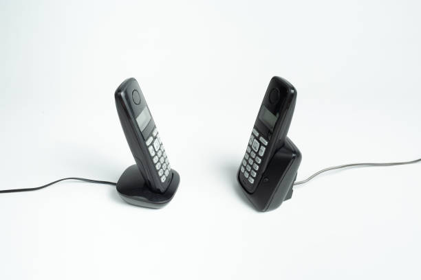 istock two outdated phones for communication on a white floor, top view 1311913509