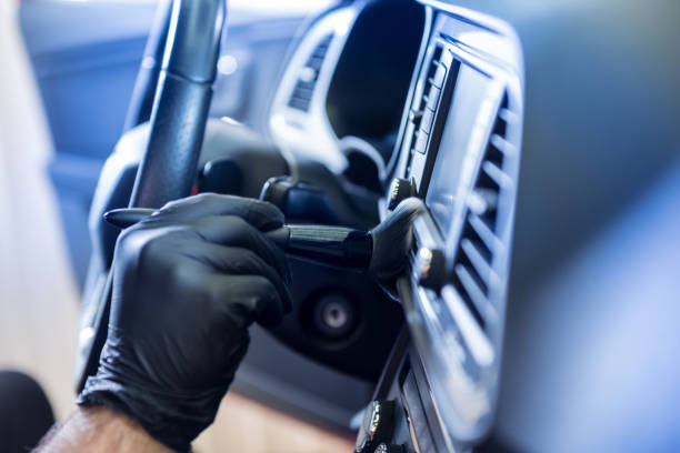 istock A car service worker cleans the car console with a special brush 1311915706