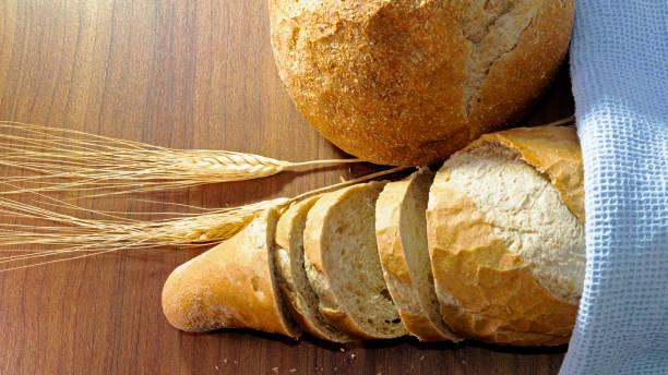 istock Various breads and dry wheat on wooden background 1311916870