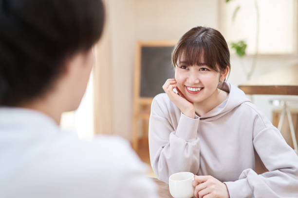 Asian men and women talking with a smile