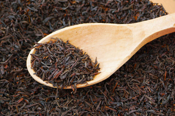 istock black loose long leaf tea in wooden spoon 1311920480