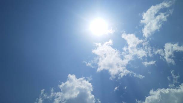 istock Ray of bright sun on blue summer cloudy sky. 1311921498