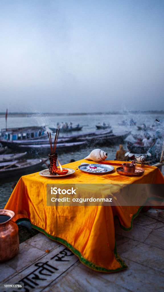 Ceremonial objects for Ganga aarti ceremony rituals at sunrise, near Ganges River, Varanasi, India Aarti - Praying Stock Photo