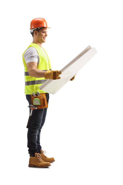 istock Full length profile shot of a construction worker looking at a blueprint 1311925443
