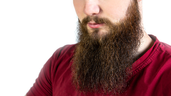 Young adult man with long beard and mustache closeup isolated on white background space for text