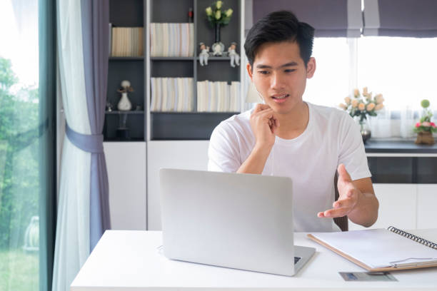 istock Young man video call conference online with his colleagues. 1311928611