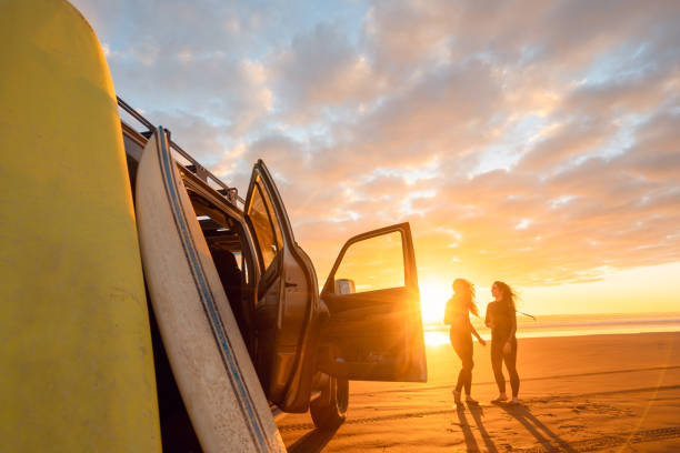 istock After surfing enjoying sunset on beach. 1311930535