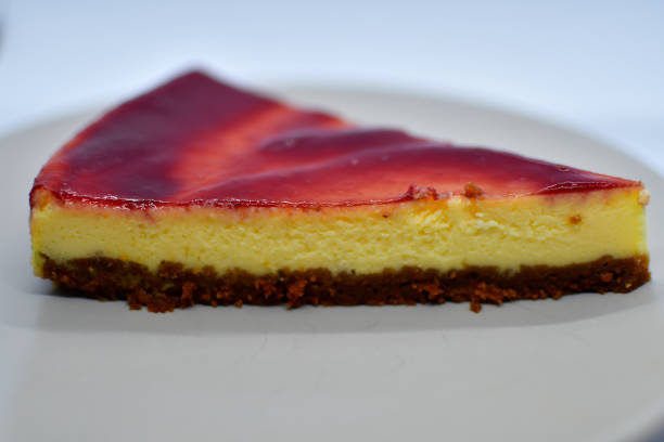 Slice of cheesecake with red fruit coulis