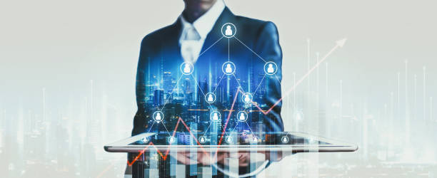 Business man using tablet on people network and digital finance marketing with city technology background Business finance technology concept, Professional business man using tablet on network city and mlm digital marketing people graphic at night in Bangkok, Thailand multi level marketing stock pictures, royalty-free photos & images