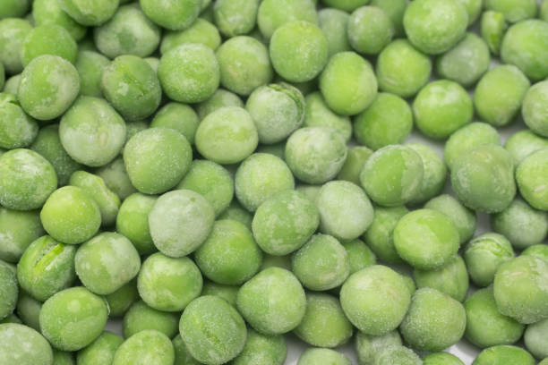 istock frozen green peas closeup selective focus 1311935193