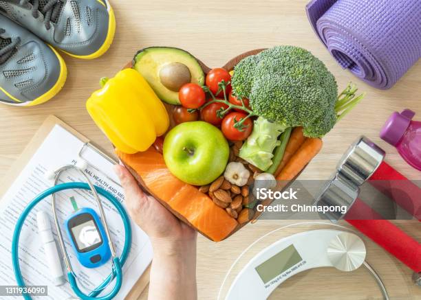 Healthy Lifestyle On Ketogenic Diet Eating Clean Keto Food Good Health Dietary In Heart Dish With Aerobic Body Exercise Gym Workout Training Class Weight Scale And Sports Shoes In Fitness Center Stock Photo - Download Image Now