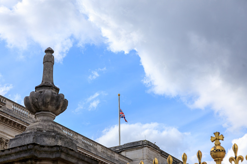 London, United Kingdom - April 9 2021: Famous and the main symbol of London Buckingham Palace and The Union Jack flag is flying at half-mast