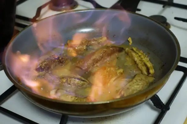 Bananas and pears cooked in butter and flambéed with rum