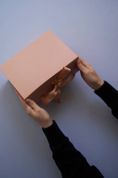 istock Woman hands open empty cardboard box, top view 1311938091