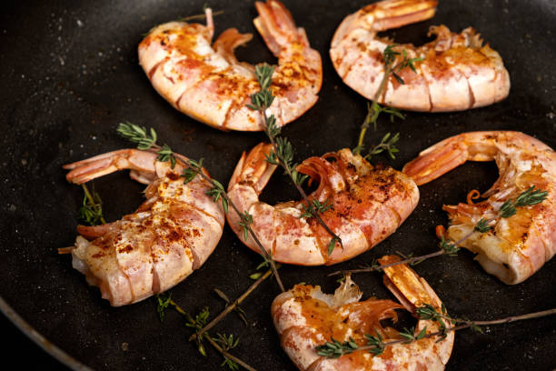 istock Shrimp fried in a frying pan on a dark background 1311939360