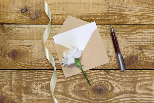 istock Simple small envelope with space for writing on wooden background with pen Narrow focus line, shallow depth of field 1311940009