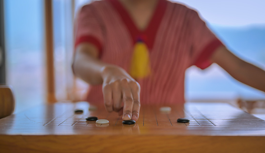 Young women playing weiqi against the other ,ancient strategic board games