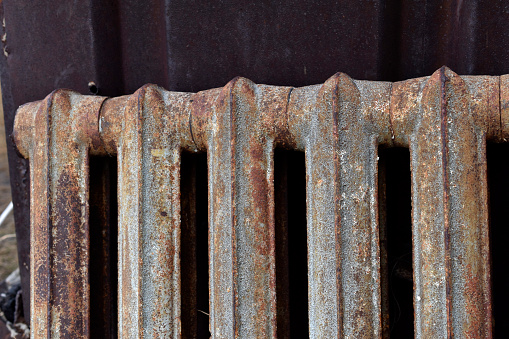 A rusty old Soviet radiator battery pack