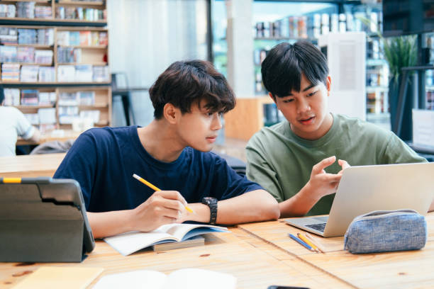 istock Young students campus helps friend catching up and learning. 1311943748