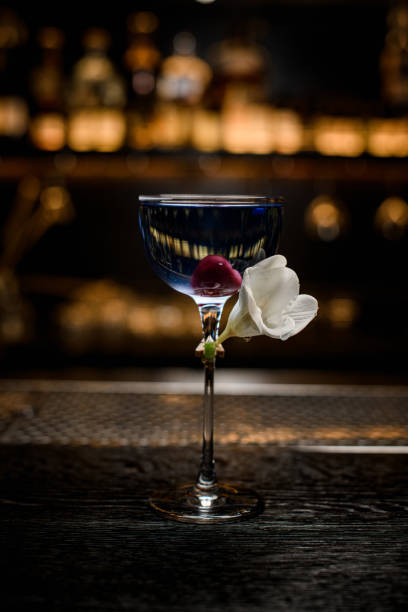 istock front view on beautiful transparent glass with blue drink decorated with white flower 1311945498