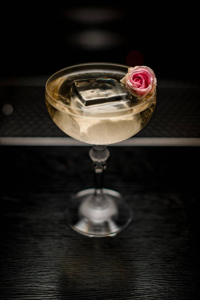 istock high angle view on glass with drink and ice cube decorated with pink flower 1311946312