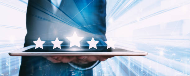 istock Business man using tablet with graphic of customer service star rate in mobile application 1311947704