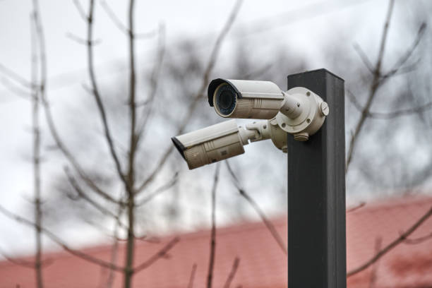 istock IP CCTV security camera on pole, urban cityscape 1311949530