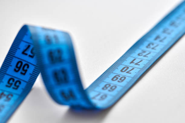 istock Blue measuring tape isolated on white background 1311949533
