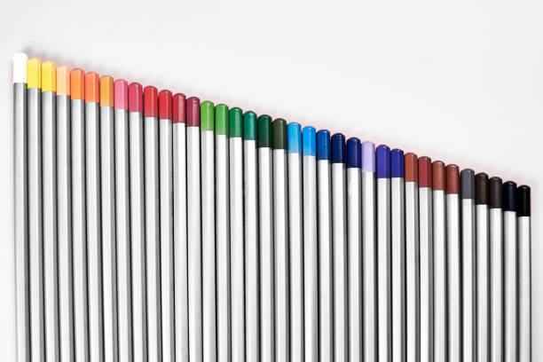 istock Colored pencils lined up in a row on a pink background. 1311950824