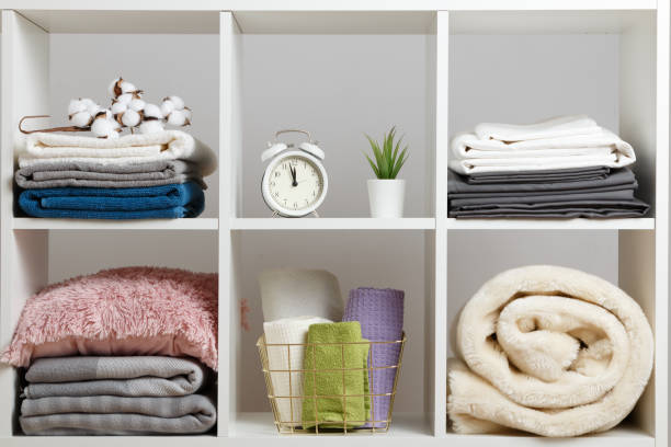 Organization of storage. Stacks of towels, sheets, bed linen, blankets and pillows on a white shelf. Organization of storage. Stacks of towels, sheets, bed linen, blankets and pillows on a white shelf. neat home stock pictures, royalty-free photos & images