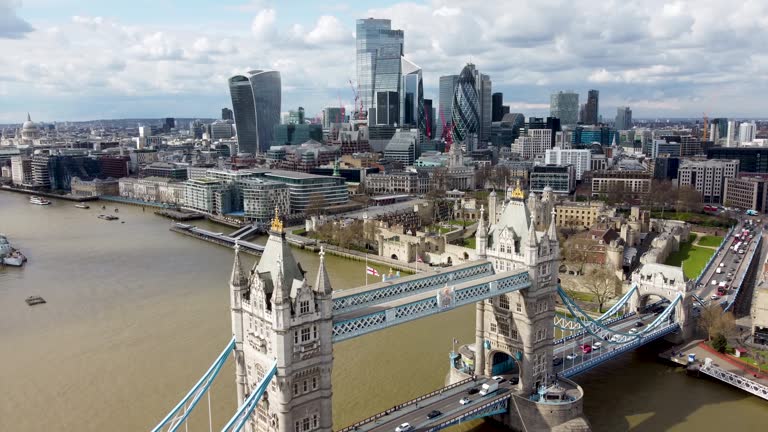 Panoramic aerial view to the Tower Bridge of London, United Kingdom, with the modern skyline of the City during a sunny day