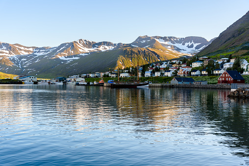 Small fishing town in a narrow fjord along the northen coast of Iceland on a clear summer day. Siglufjordur, Iceland.