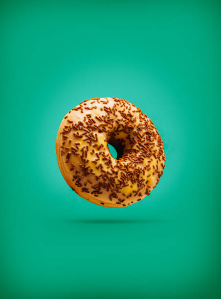 istock Freshly baked donuts isolated on colourful background 1311955110