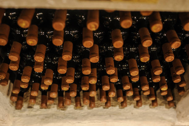 istock Wine bottles stacked up in old wine cellar 1311955298