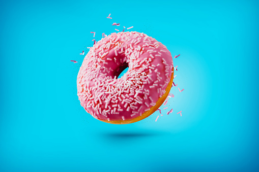 Freshly baked donuts isolated on colourful background